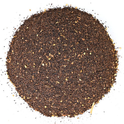 Round pile of coarse ground black loose-leaf tea.