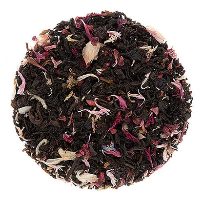 Round black tea ball with floral petals on a white background