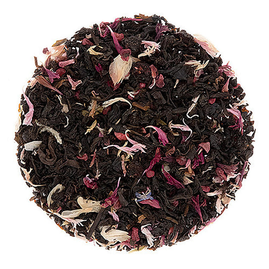 Round black tea ball with floral petals on a white background