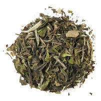 A pile of dry Pai Mu Tan white tea leaves with a slightly pale and withered appearance.