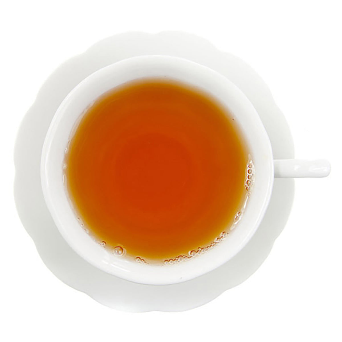 White cup and saucer with amber colored rooibos tea all on a white background