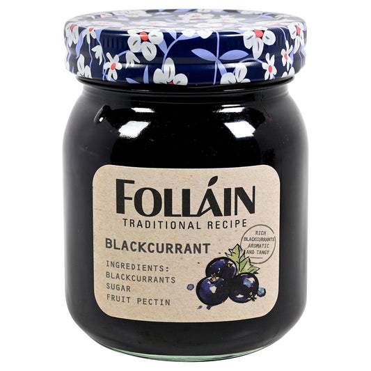 Jar of Folláin blackcurrant jam with floral lid on a white background