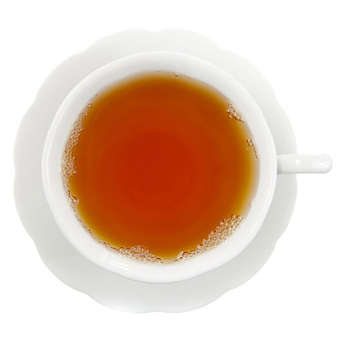 White cup and saucer with a steaming cup of rooibos amber colored tea on a white background
