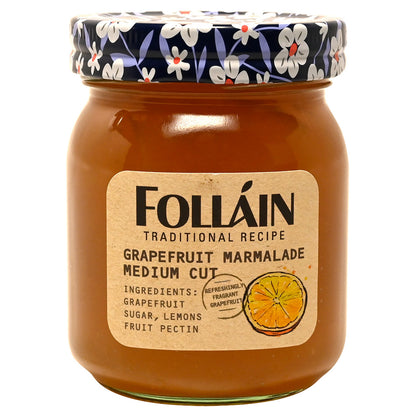 Jar of Folláin grapefruit marmalade with decorative lid on a white background