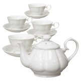White porcelain teapot and cups with saucers on a white background