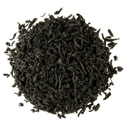 Dry black tea leaves on a white background
