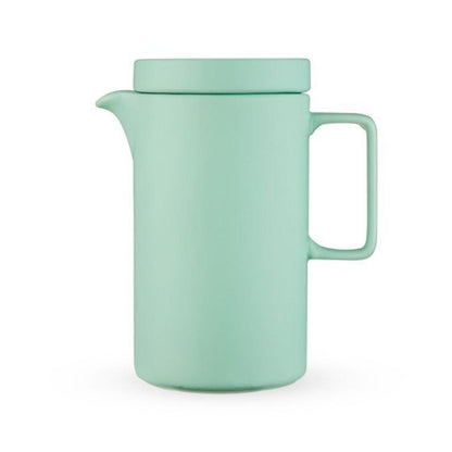 Mint green tall tea pot on a white background