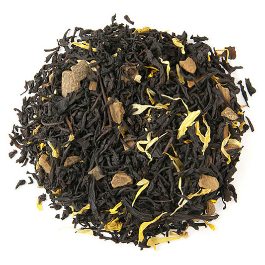 A close-up of Cinna-Vanilla Flavored Black Tea loose leaf, showing black tea leaves interspersed with pieces of cinnamon and vanilla flakes.