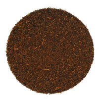 A close-up image of loose-leaf Kenyan and Assam black tea on a white background.