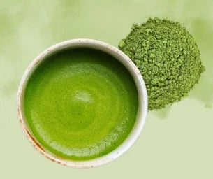 Green matcha powder in a bowl on a green background