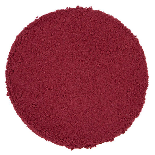 Round pile of coarse ground red colored tea leaves on a white background