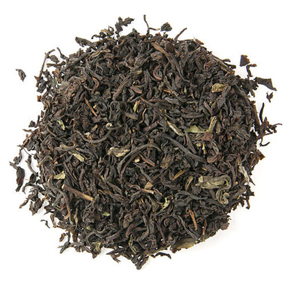 Dry black tea leaves on a white background