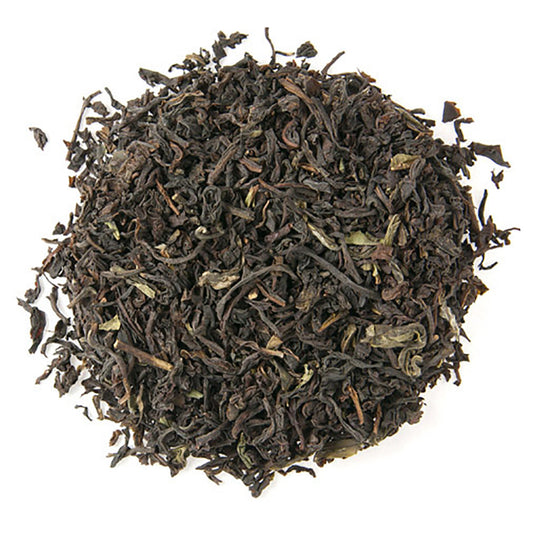 Dry black tea leaves on a white background