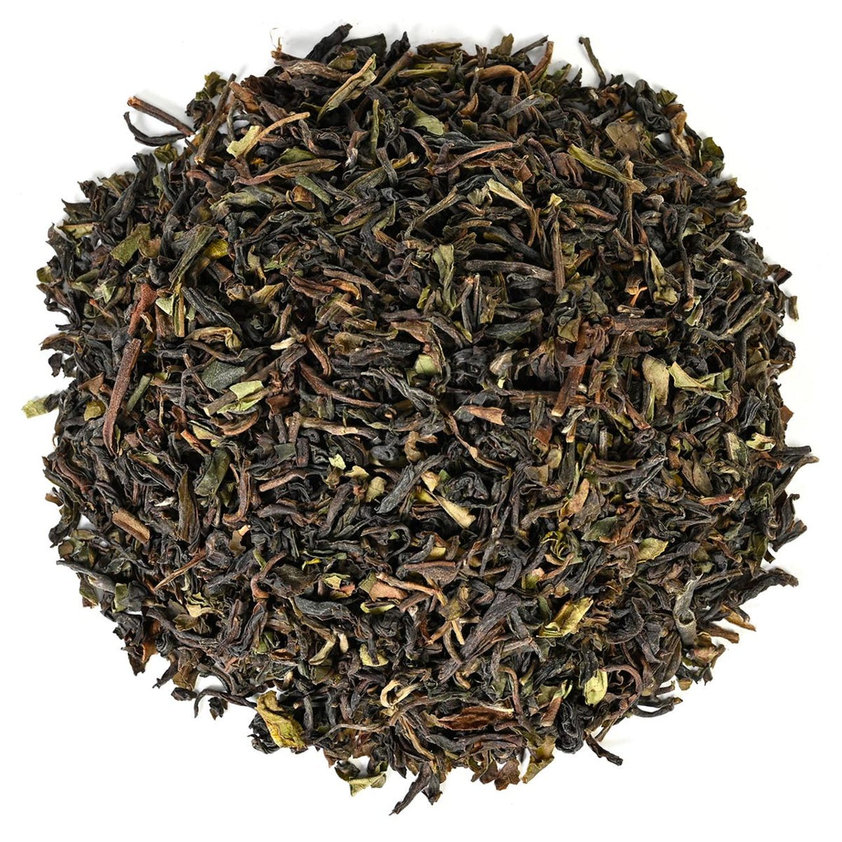 Dry dark tealeaves in a circular pattern all on a white background.