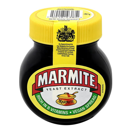 Jar of Marmite yeast extract with yellow lid on a white background