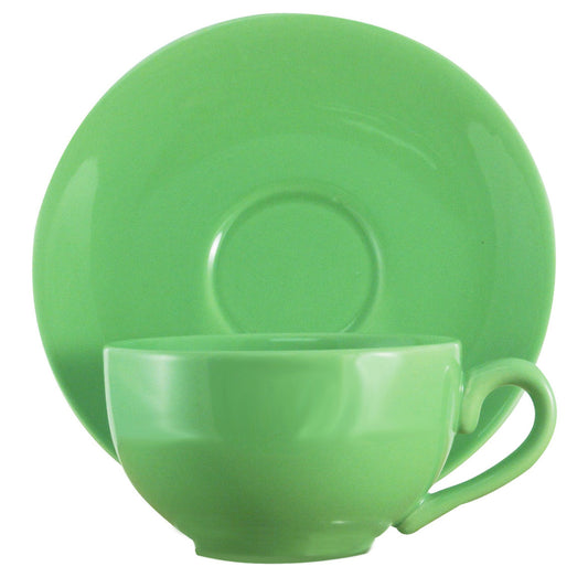 Green ceramic cup and saucer set on a white background
