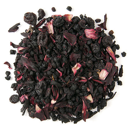 Dried hibiscus flowers and black tea on a white background