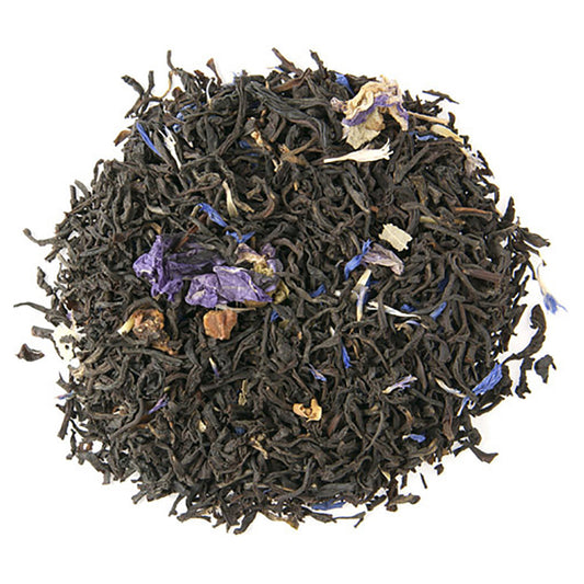 Loose leaf black tea with pieces of dried apple and colorful dried petals scattered throughout.