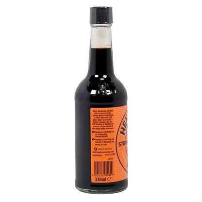 Bottle of Henderson's Strong Relish Sauce on a white background