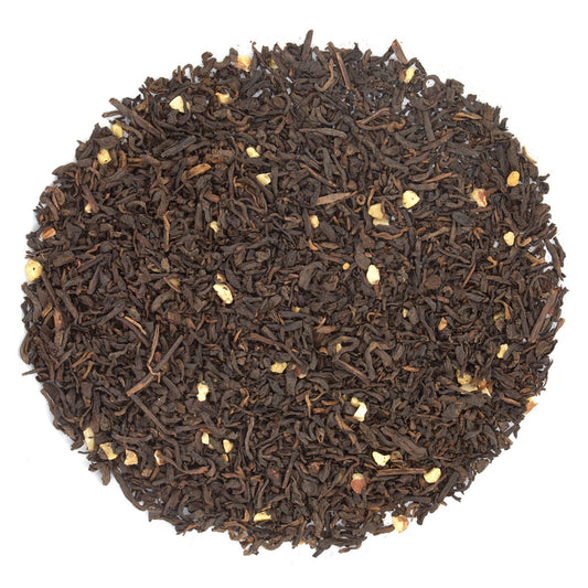 Close-up of black tea leaves on a white background