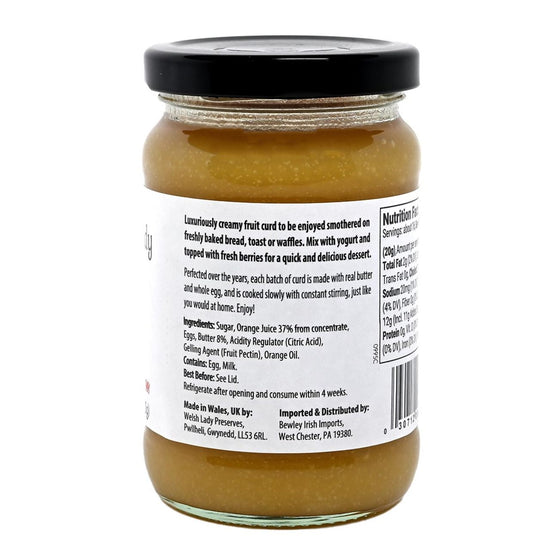 Jar of Welsh Lady Orange Curd 'All Butter' on a white background with the jar showing the white label and black font featuring the ingredients list