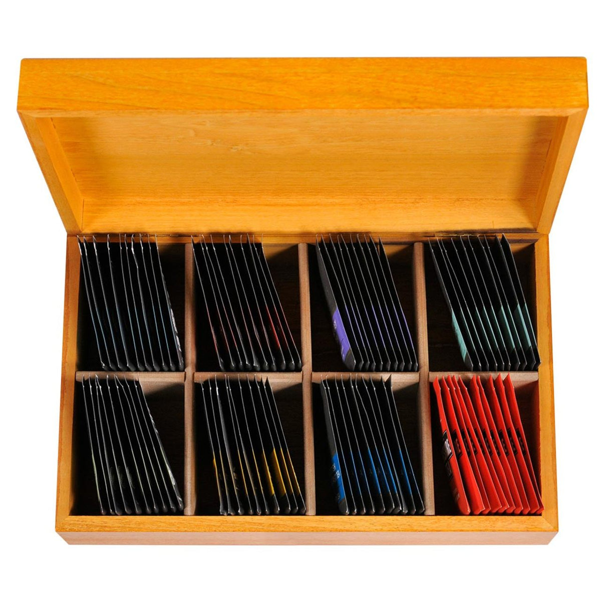 Light wooden tea box on a white background opened to show colorful individually wrapped teabags inside