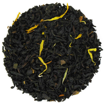 Black tea leaves with yellow strands on a white background