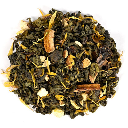 Tea leaves with visible spices and flowers on a white background