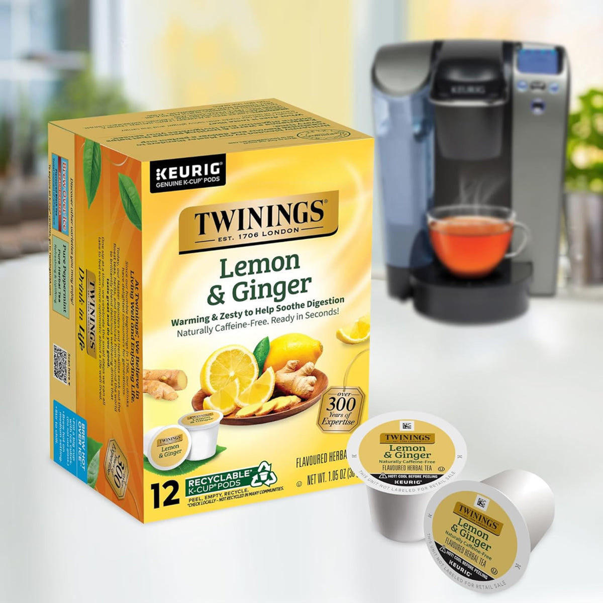 Box of Twinings Lemon & Ginger tea K-cups with a Keurig machine in the background.
