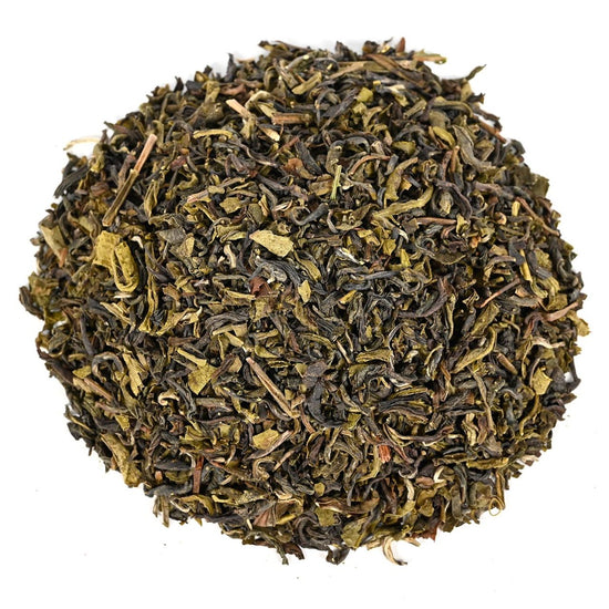Close-up of green tea leaves on a white background