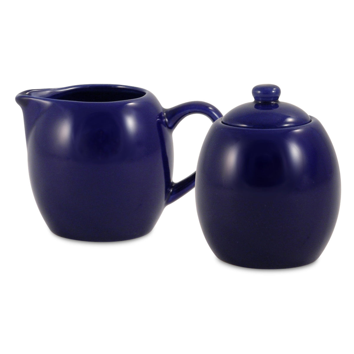 Navy blue ceramic creamer and sugar bowl set on a white background
