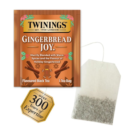 Twinings Gingerbread Joy tea package with a tea bag on a white background