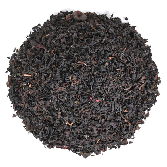 Close-up of black tea leaves on a white background