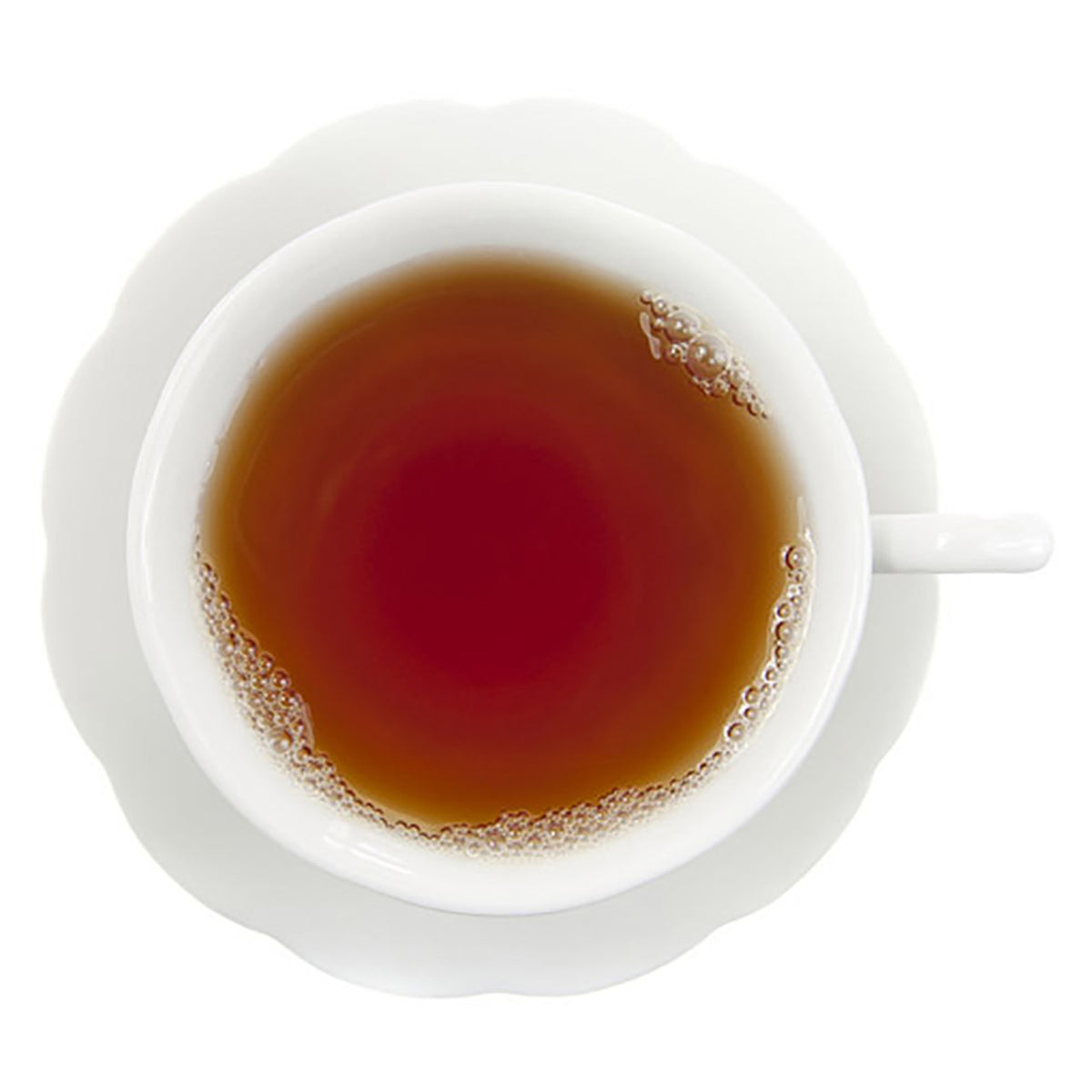 White cup filled with dark hot tea on a white background