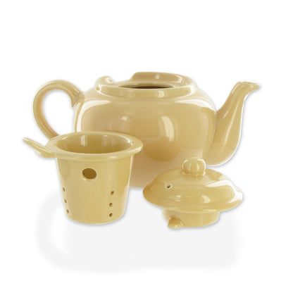 Set of Amsterdam yellow teapot, lid, and strainer on a white background