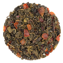 A close-up of Pomegranate Hibiscus Green Tea loose leaves with pieces of hibiscus petals and rosehips visible.