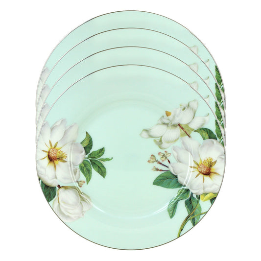 Set of four blue magnolia bone plates with floral design on a light green background