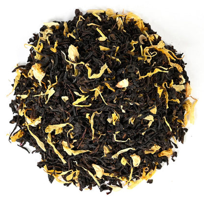 Loose-leaf black tea mixed with yellow petals and dried fruit pieces.