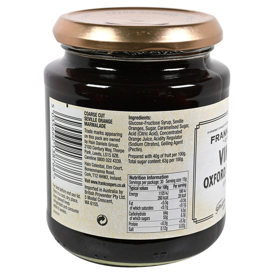 Side view of a jar of Frank Cooper's Vintage Oxford Marmalade with a gold lid on a white background.  Side view of the label listing the ingredients and nutrition information.