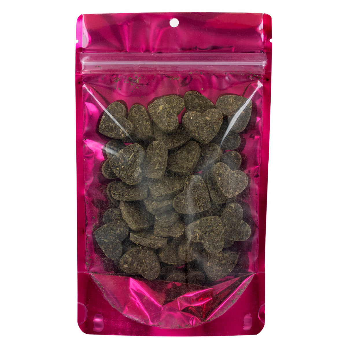 Pink transparent bag with heart-shaped dark green tea leaves pressed into hearts with the package on a white background