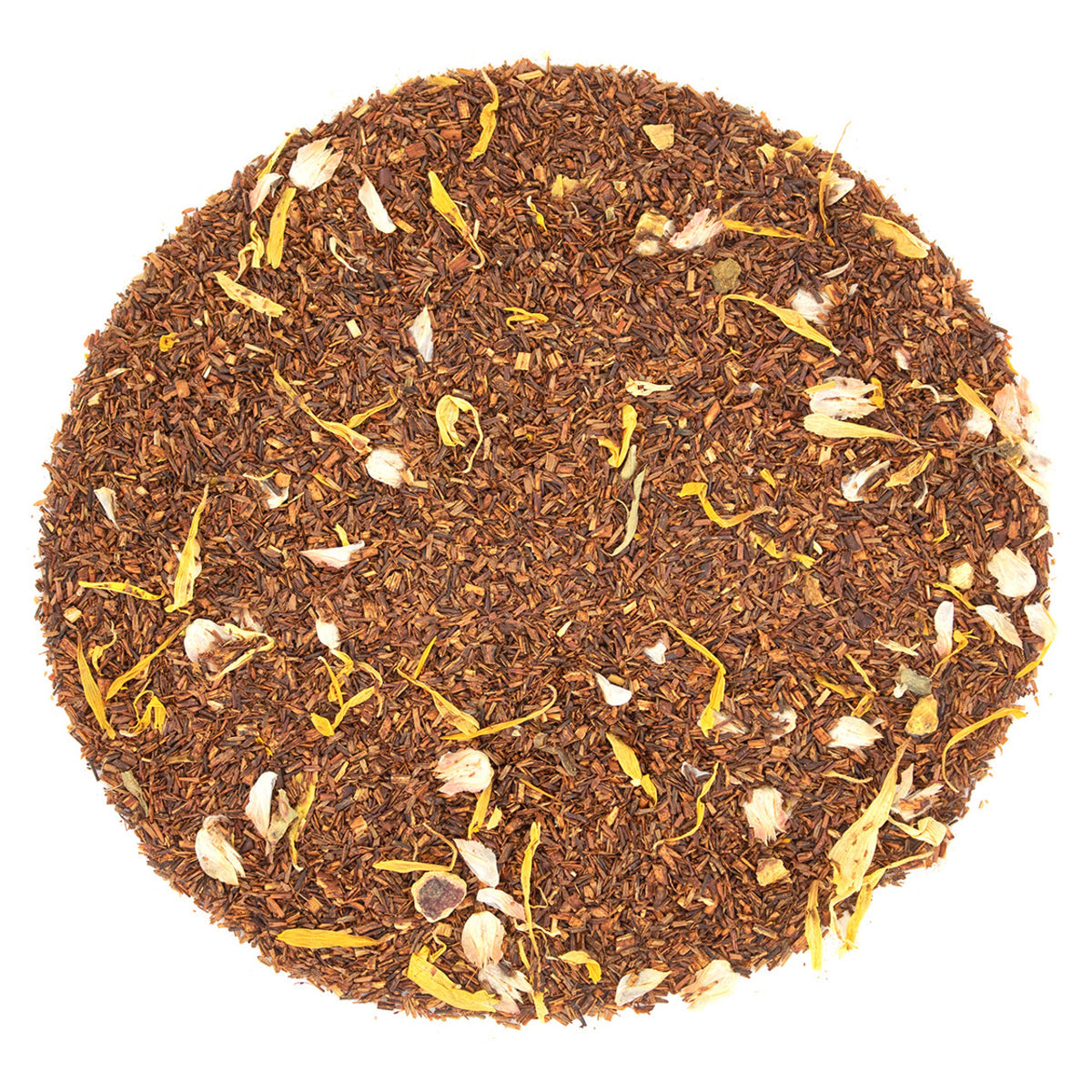 Round pattern of dry amber colored tea leaves on a white background