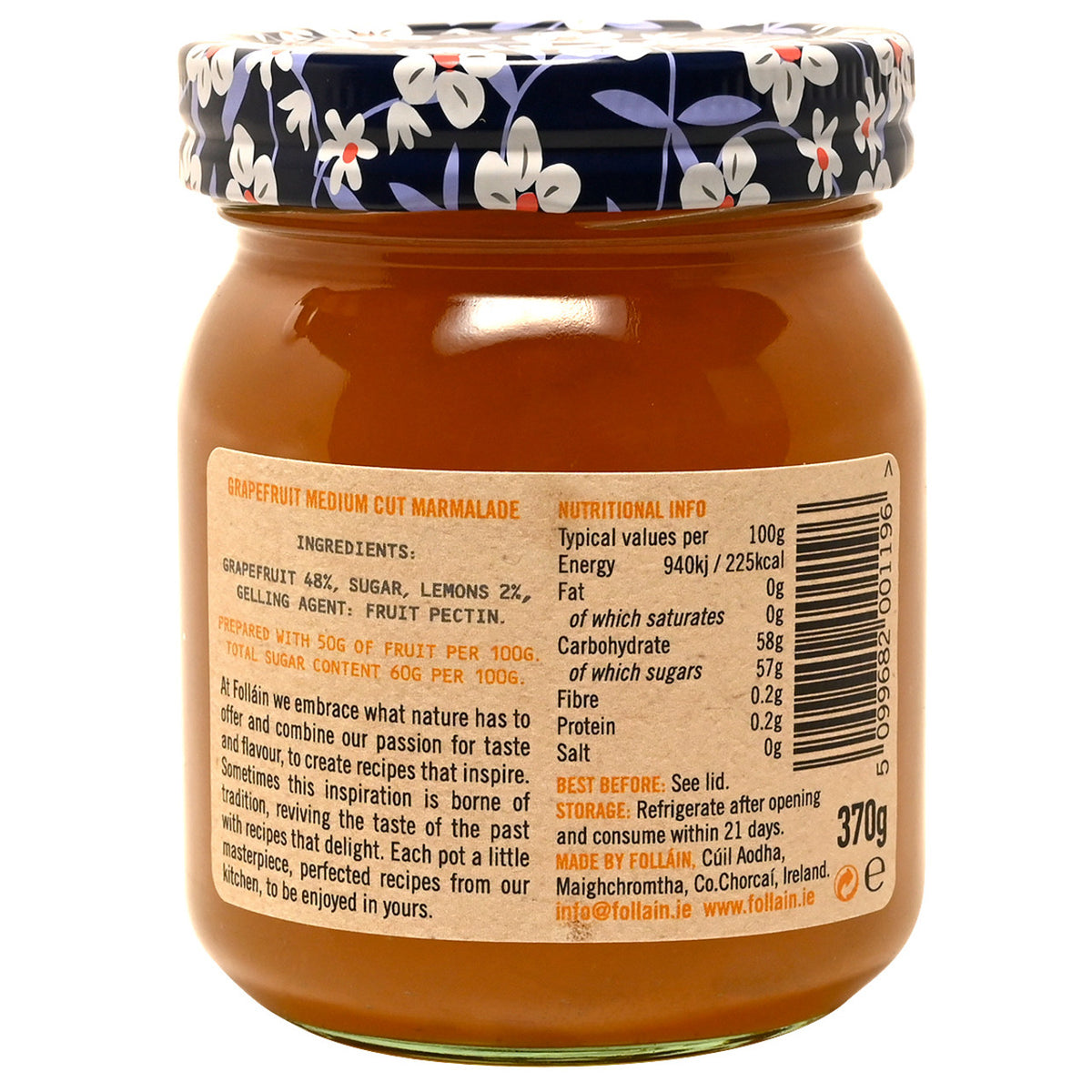 Jar of Follain grapefruit marmalade with floral lid on a white background