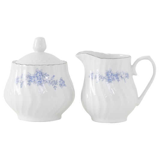 White porcelain sugar bowl and creamer set with blue floral patterns on a white background