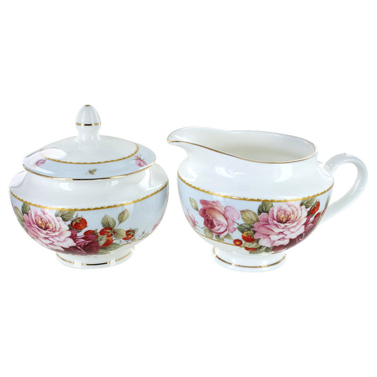 White bone china sugar bowl and creamer set with floral design on a white background