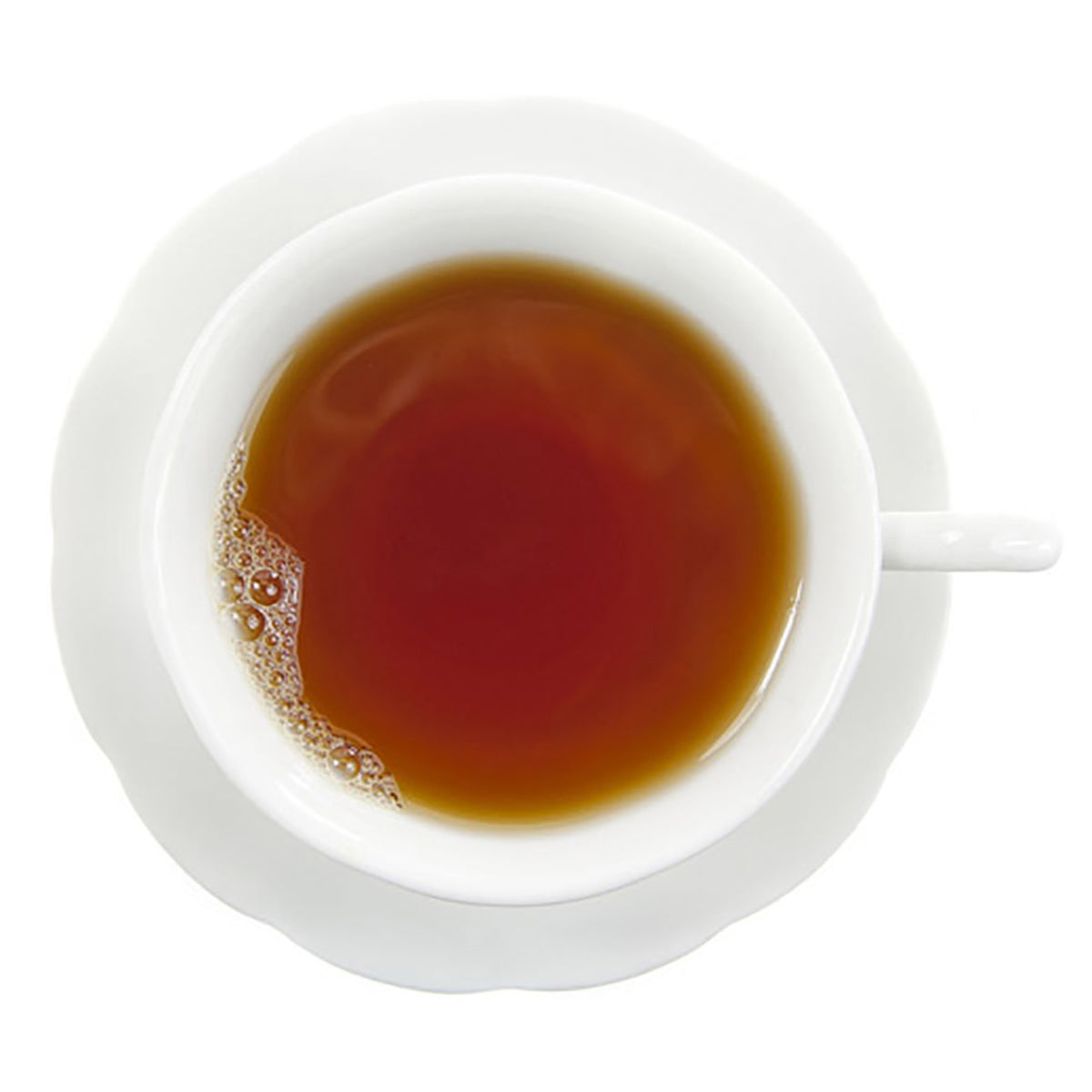 White cup filled with dark hot tea on a white background