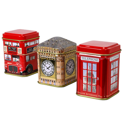Three tea tins with London-themed designs featuring double decker bus, Big Ben, and a red phone booth all on a white background