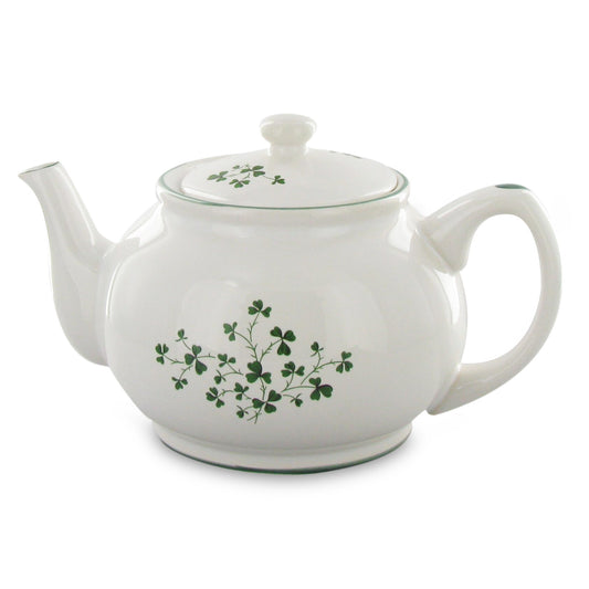 White teapot with green floral design on a white background