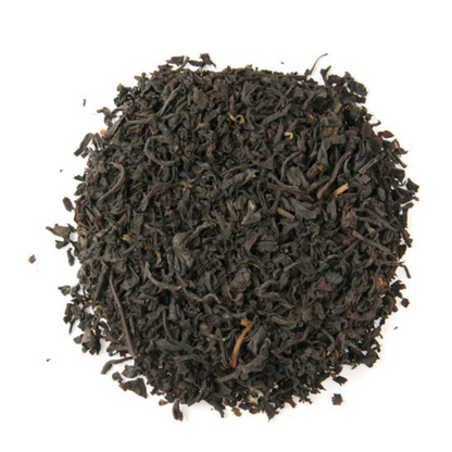 Dry black tea leaves on a white background