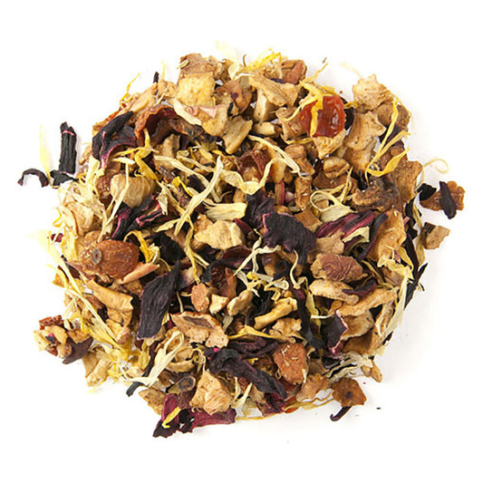 A pile of dried loose leaf herbal tea with visible pieces of apple, hibiscus, rosehip, orange, and calendula petals.