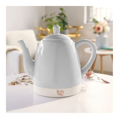 White electric kettle on a table with a blurred background